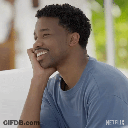 Man In Blue Shirt Smiling With Hand On Chin GIF