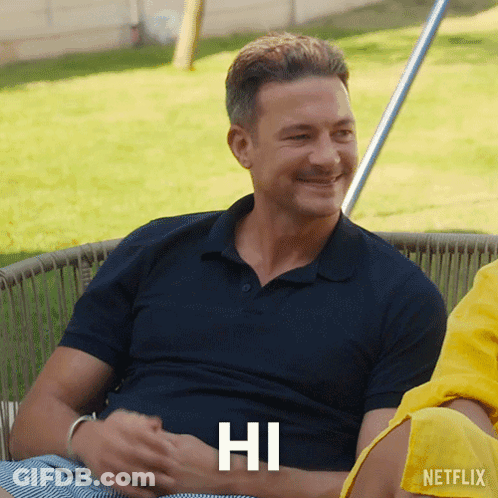 Man In Blue Shirt Smiling With Hi On Chest GIF