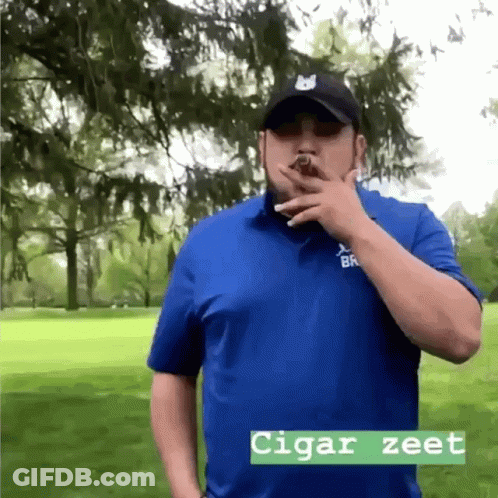 Man In Blue Shirt Smoking Cigar Saying Cigar Zeet GIF