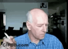 Man In Blue Shirt Smoking Cigarette GIF