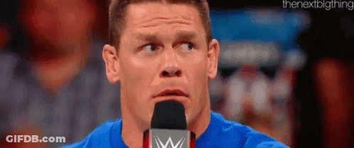 Man In Blue Shirt Speaking Into Microphone GIF