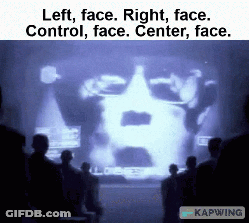 Man In Blue Shirt Speaking Into Microphone GIF