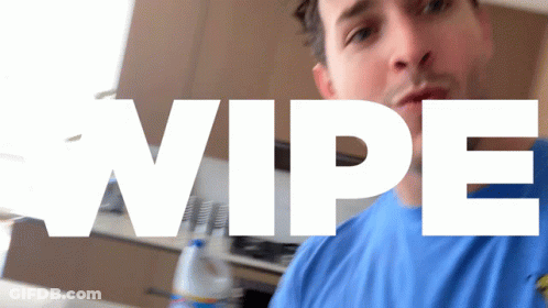 Man In Blue Shirt Standing At Wipe Sign GIF