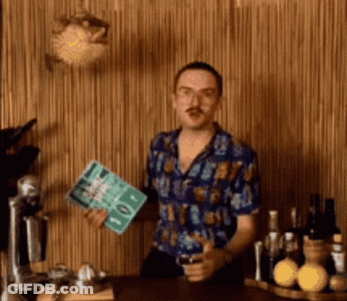 Man In Blue Shirt Standing By Wooden Wall GIF