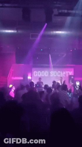Man In Blue Shirt Standing In Crowd GIF