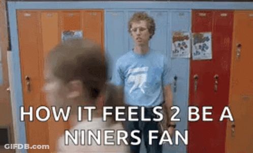 Man In Blue Shirt Standing In Front Of Gym Lockers GIF