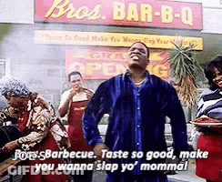 Man In Blue Shirt Standing In Front Of Restaurant GIF