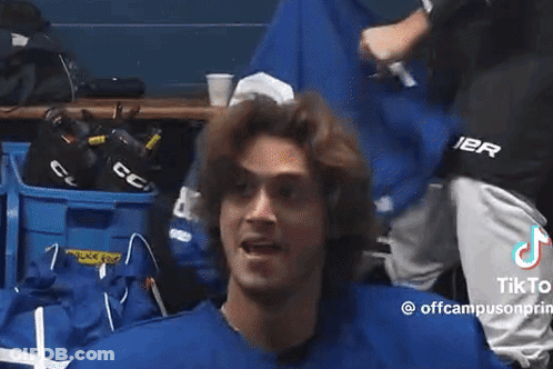 Man In Blue Shirt Standing In Locker Room GIF
