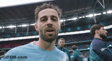 Man In Blue Shirt Standing In Stadium With Mouth Open GIF