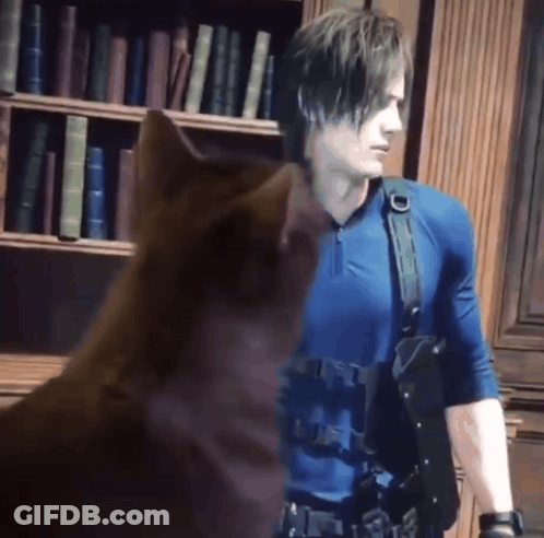 Man In Blue Shirt Standing Next To Brown Cat GIF