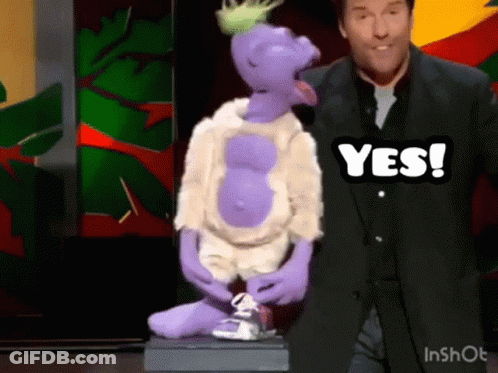 Man In Blue Shirt Standing Next To Puppet GIF