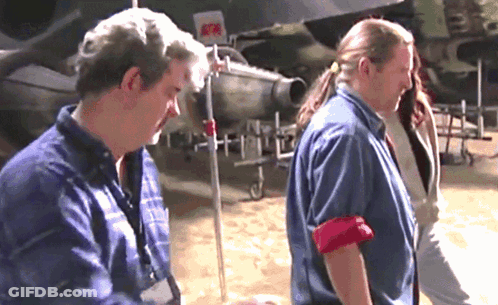 Man In Blue Shirt Standing Next To Woman GIF