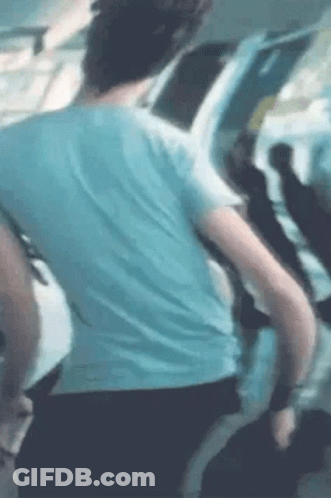 Man In Blue Shirt Standing With Group On Plane GIF
