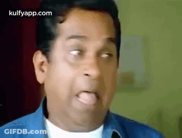 Man In Blue Shirt Sticking Tongue Out GIF