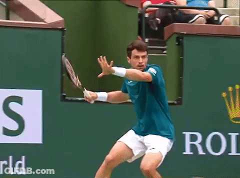 Man In Blue Shirt Swinging Tennis Racket GIF
