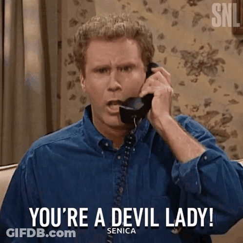 Man In Blue Shirt Talking On Telephone Saying You're A Devil Lady GIF