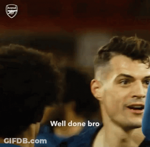 Man In Blue Shirt Talking To Another In Crowd GIF