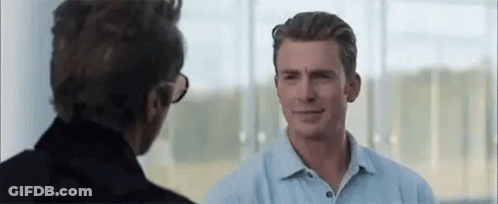 Man In Blue Shirt Talking To Man In Black Jacket GIF