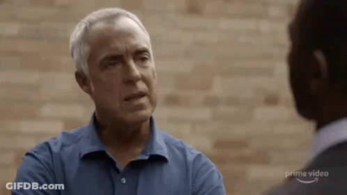 Man In Blue Shirt Talking To Man In Grey Suit GIF