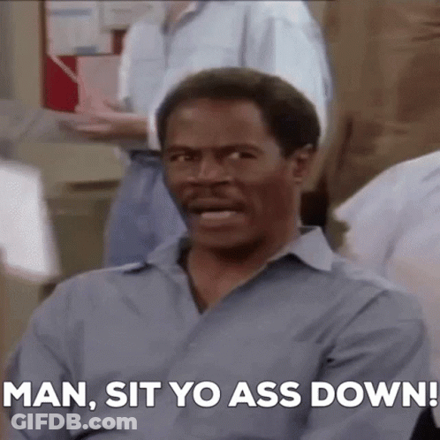 Man In Blue Shirt Telling People To Sit GIF