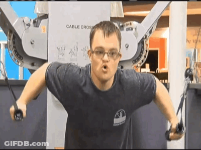 Man In Blue Shirt Using Cable Cross Machine GIF