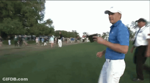 Man In Blue Shirt Walking On Golf Course GIF