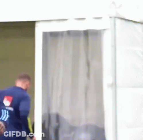 Man In Blue Shirt Walking Out Of Tent GIF