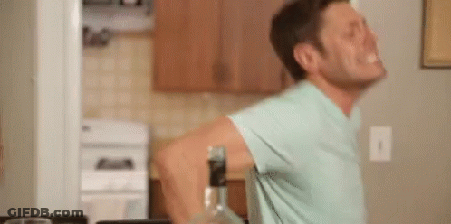 Man In Blue Shirt With Bottle Of Alcohol GIF