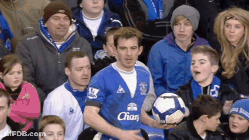 Man In Blue Shirt With Chan Holding Soccer Ball GIF