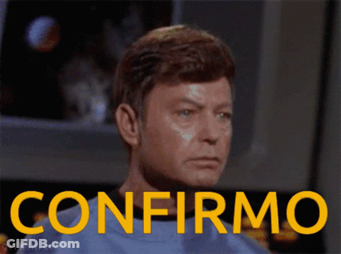 Man In Blue Shirt With Confirmo In Yellow Letters GIF