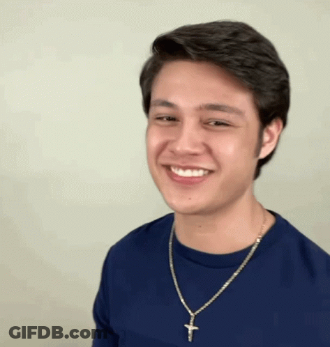 Man In Blue Shirt With Cross Necklace Smiling GIF