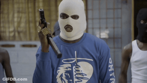 Man In Blue Shirt With Faith Text Holding Gun GIF