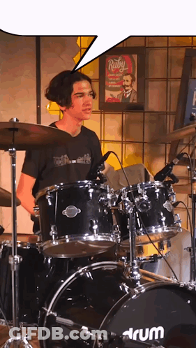 Man In Blue Shirt With Heart Playing Drums GIF