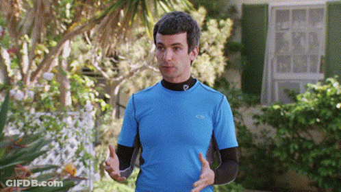 Man In Blue Shirt With Letter P Standing In Front Of House GIF