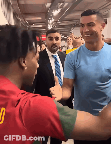 Man In Blue Shirt With Number 10 Talking To Another Man GIF