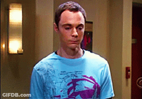 Man In Blue Shirt With Purple Design Standing In Room GIF