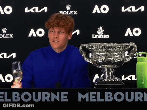 Man In Blue Shirt With Rolex And Emirates Ad GIF