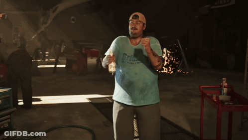 Man In Blue Shirt With RPM In Garage GIF