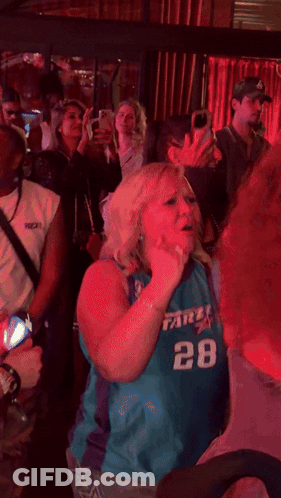 Man In Blue Shirt With S Dancing In Crowd GIF