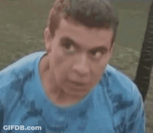 Man In Blue Shirt With Serious Look GIF