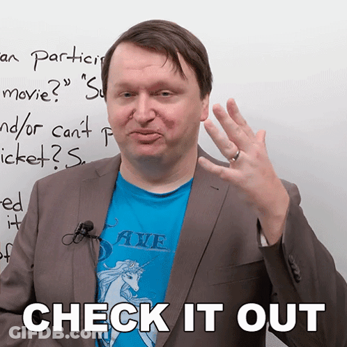 Man In Blue Shirt With Unicorn And Words Check It Out Behind Him GIF