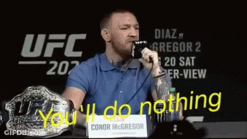 Man In Blue Shirt You'll Do Nothing Sign GIF