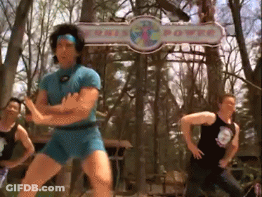 Man In Blue Shorts Dancing Near This Power Sign GIF
