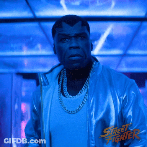Man In Blue Street Fighter Jacket Dark Room GIF