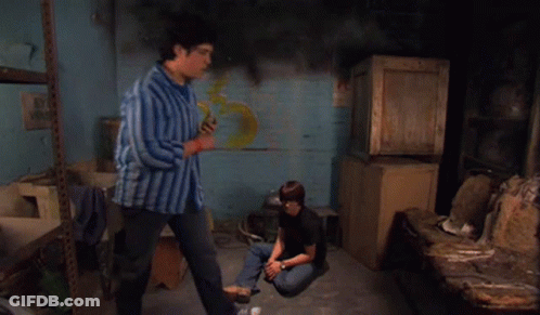 Man In Blue Striped Shirt Standing Next To Boy Sitting On Floor GIF
