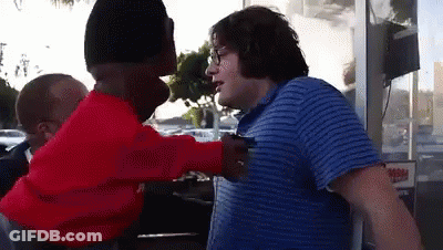 Man In Blue Striped Shirt Talking To Man In Red Sweater GIF