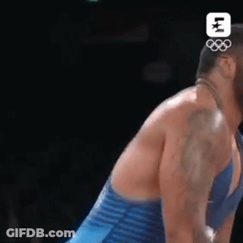 Man In Blue Striped Shirt Wrestling Another Man GIF
