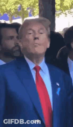 Man In Blue Suit And Red Tie Making Funny Face GIF