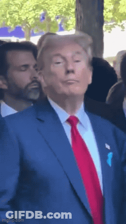 Man In Blue Suit And Red Tie Making Funny Face GIF