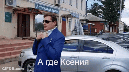 Man In Blue Suit And Sunglasses By Silver Car GIF